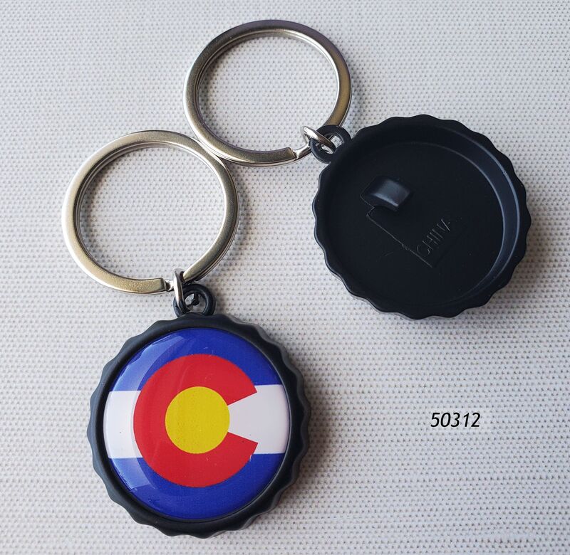 50312 Colorado Souvenir Keyring. Circle Flag design inset into a matte black "bottlecap" with crinkled edges.  Backside has a hook for bottle opener.  Shiny silver keyring attachment. 