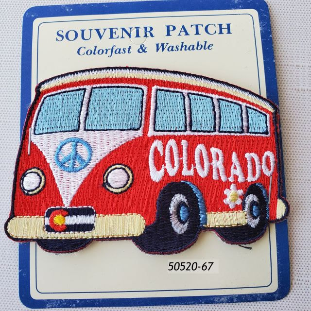 50520-67 Colorado Souvenir Embroidered Patch.  Die cut in the shape of a van, red color with Colorado flag and lettering. On hang card for display