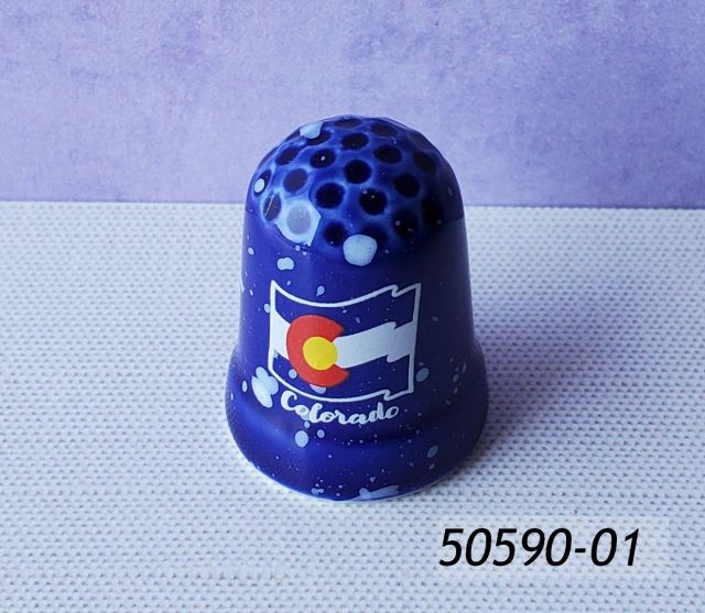 50590-01 Colorado Souvenir thimble, blue porcelain with speckle motif and a Colorado Flag design. 