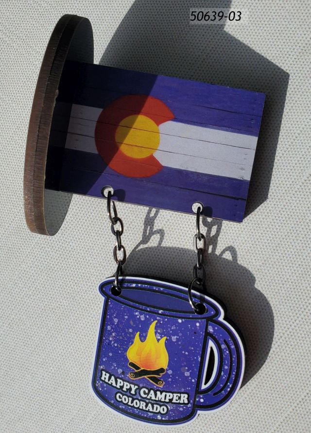 50639-03 Colorado Souvenir Fiberboard magnet with flag up top and two chains holding another segment that looks like a blue enamel campfire mug